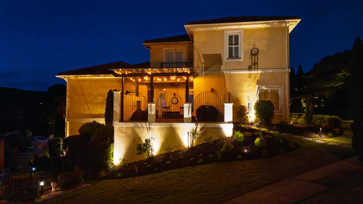 Luxury Italian-style home with professional landscape lighting in Greenville SC
